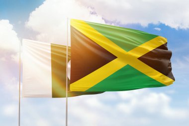 Sunny blue sky and flags of jamaica and pakistan