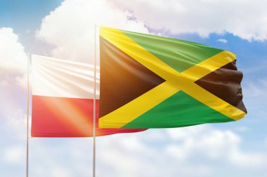 Sunny blue sky and flags of jamaica and poland