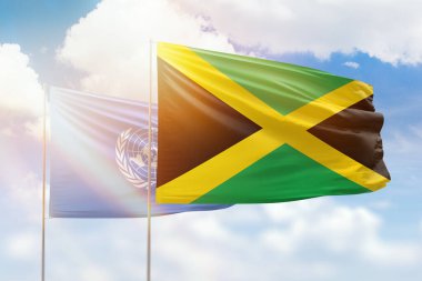 Sunny blue sky and flags of jamaica and united nations
