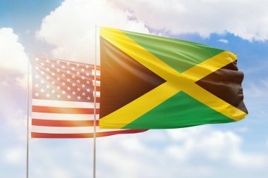 Sunny blue sky and flags of jamaica and usa