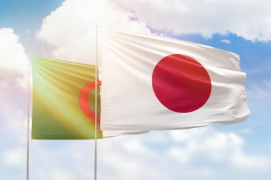 Sunny blue sky and flags of japan and algeria