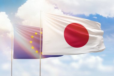 Sunny blue sky and flags of japan and european union