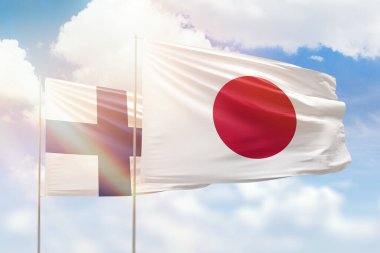 Sunny blue sky and flags of japan and finland