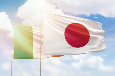 Sunny blue sky and flags of japan and ireland
