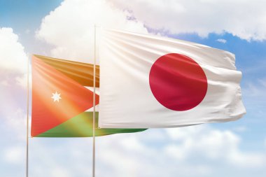 Sunny blue sky and flags of japan and jordan