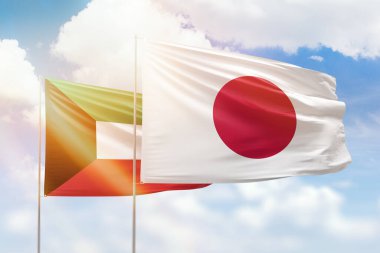Sunny blue sky and flags of japan and kuwait