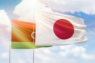 Sunny blue sky and flags of japan and libya