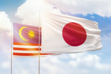 Sunny blue sky and flags of japan and malaysia