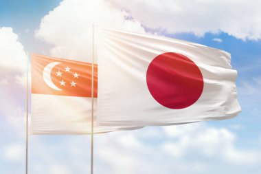 Sunny blue sky and flags of japan and singapore