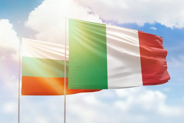 Sunny blue sky and flags of italy and bulgaria