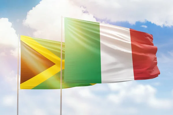 Sunny blue sky and flags of italy and jamaica