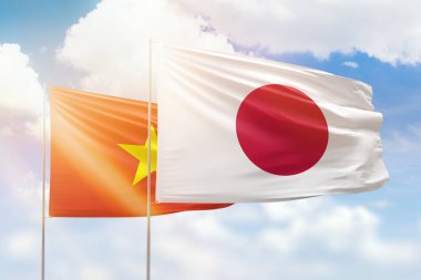 Sunny blue sky and flags of japan and vietnam