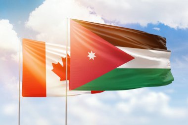 Sunny blue sky and flags of jordan and canada