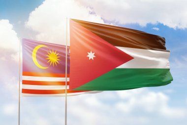 Sunny blue sky and flags of jordan and malaysia