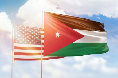 Sunny blue sky and flags of jordan and usa