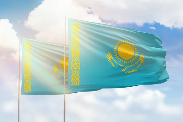Sunny blue sky and flags of kazakhstan and kazakhstan