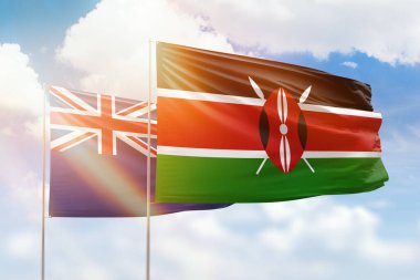 Sunny blue sky and flags of kenya and new zealand