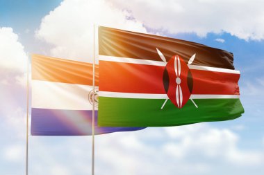 Sunny blue sky and flags of kenya and paraguay