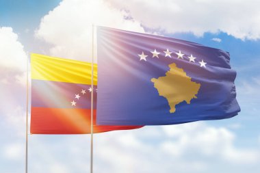 Sunny blue sky and flags of kosovo and venezuela