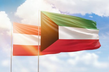 Sunny blue sky and flags of kuwait and austria