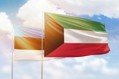 Sunny blue sky and flags of kuwait and estonia