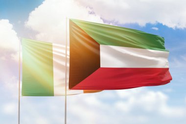 Sunny blue sky and flags of kuwait and ireland