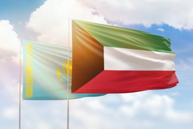 Sunny blue sky and flags of kuwait and kazakhstan