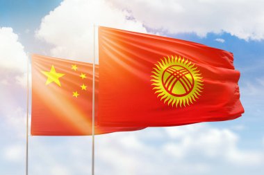 Sunny blue sky and flags of kyrgyzstan and china