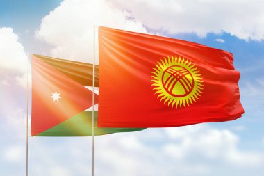 Sunny blue sky and flags of kyrgyzstan and jordan
