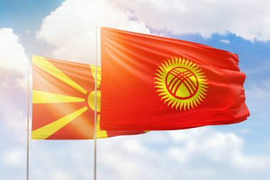 Sunny blue sky and flags of kyrgyzstan and north macedonia