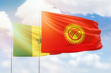 Sunny blue sky and flags of kyrgyzstan and senegal