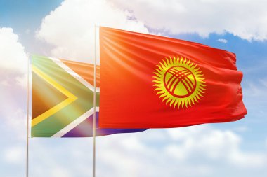Sunny blue sky and flags of kyrgyzstan and south africa