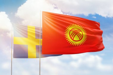 Sunny blue sky and flags of kyrgyzstan and sweden