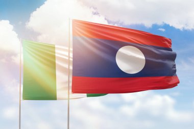 Sunny blue sky and flags of laos and nigeria
