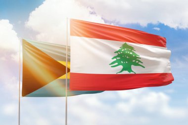 Sunny blue sky and flags of lebanon and bahamas