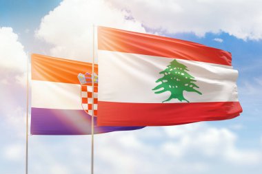 Sunny blue sky and flags of lebanon and croatia