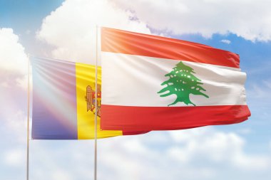 Sunny blue sky and flags of lebanon and moldova