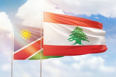 Sunny blue sky and flags of lebanon and namibia