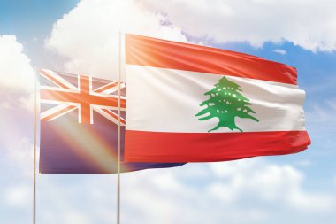 Sunny blue sky and flags of lebanon and new zealand
