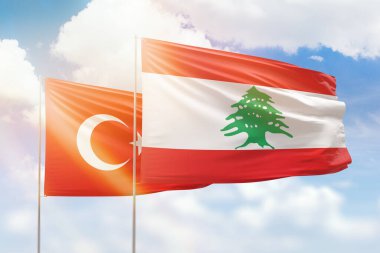 Sunny blue sky and flags of lebanon and turkey