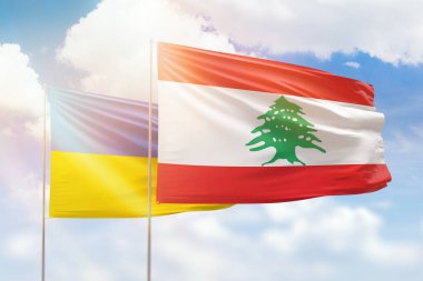 Sunny blue sky and flags of lebanon and ukraine