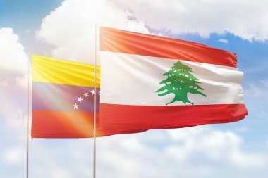 Sunny blue sky and flags of lebanon and venezuela