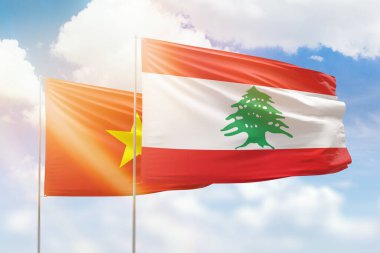Sunny blue sky and flags of lebanon and vietnam