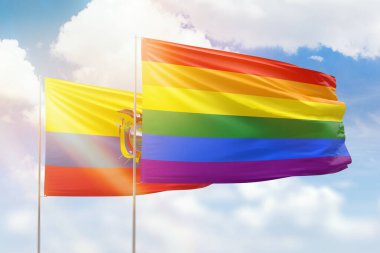 Sunny blue sky and flags of lgbt and ecuador