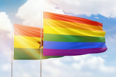 Sunny blue sky and flags of lgbt and ghana