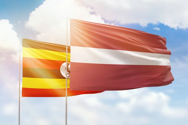 Sunny Blue Sky Flags Latvia Uganda — Stock fotografie
