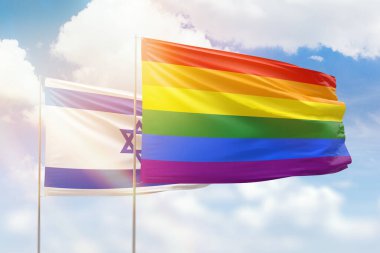 Sunny blue sky and flags of lgbt and israel