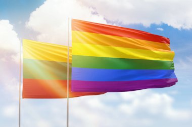 Sunny blue sky and flags of lgbt and lithuania