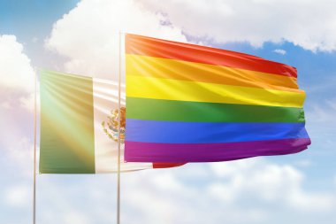 Sunny blue sky and flags of lgbt and mexico