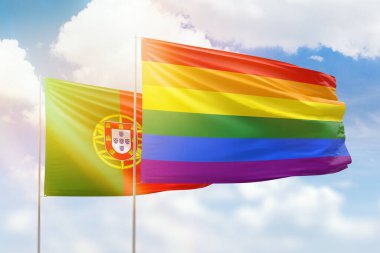 Sunny blue sky and flags of lgbt and portugal